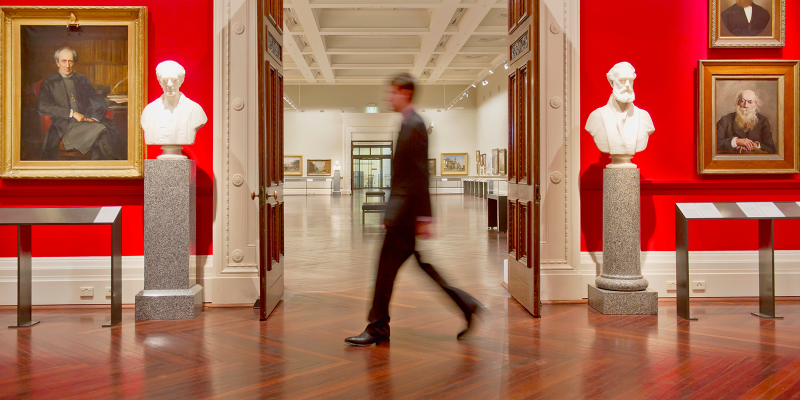 Photo of a man walking through a museum exhibit.